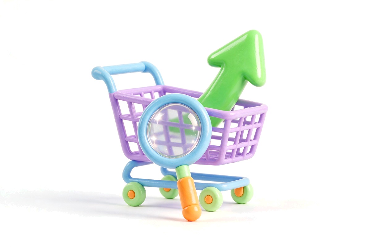 A shopping cart with a magnifying glass and a rising green arrow