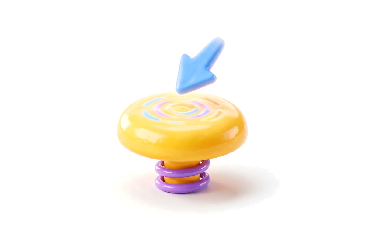 A round yellow button on a spring with a pointer arrow about to press it