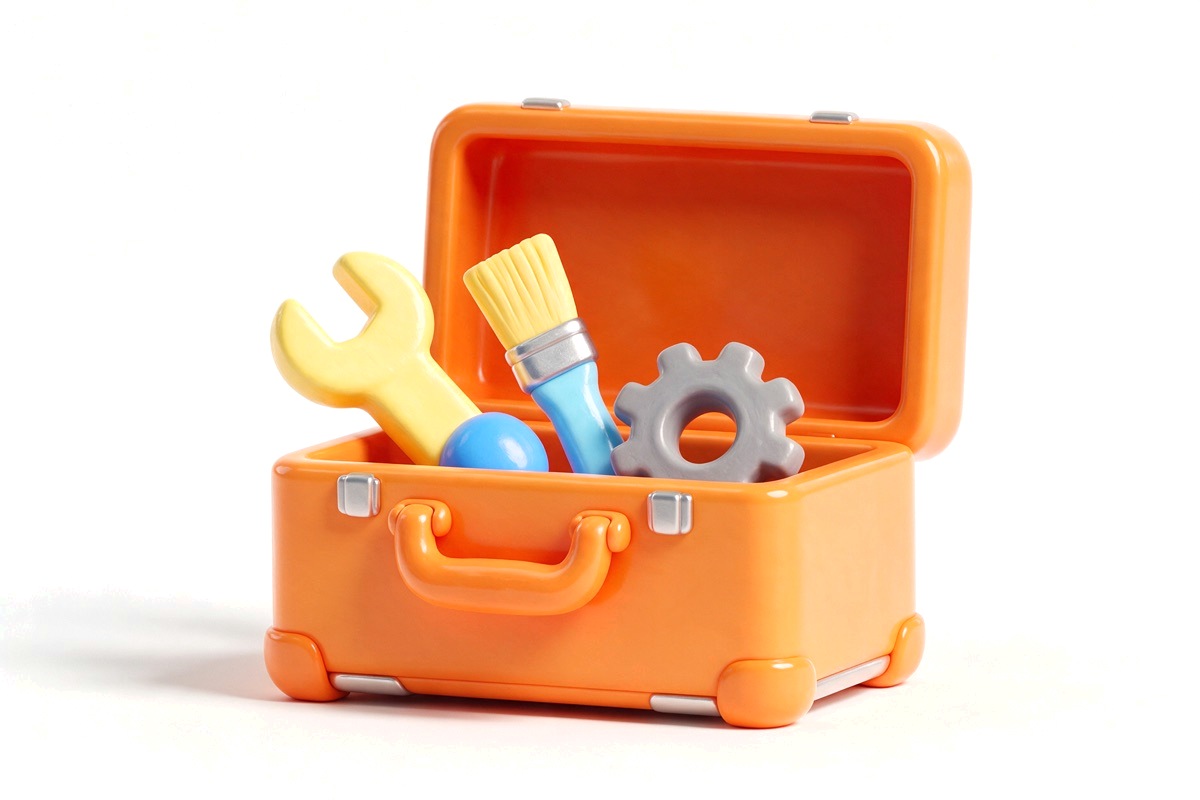 Open toolbox holding a wrench, a paintbrush and a small gear