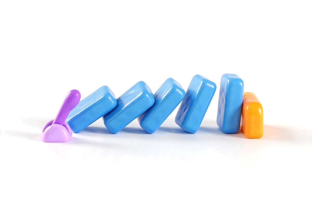 Row of blue dominoes tipping toward an orange stop block, with a purple lever