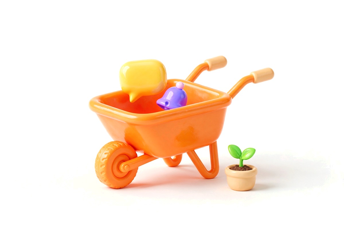 Orange wheelbarrow carrying a speech bubble and bell next to a small sapling