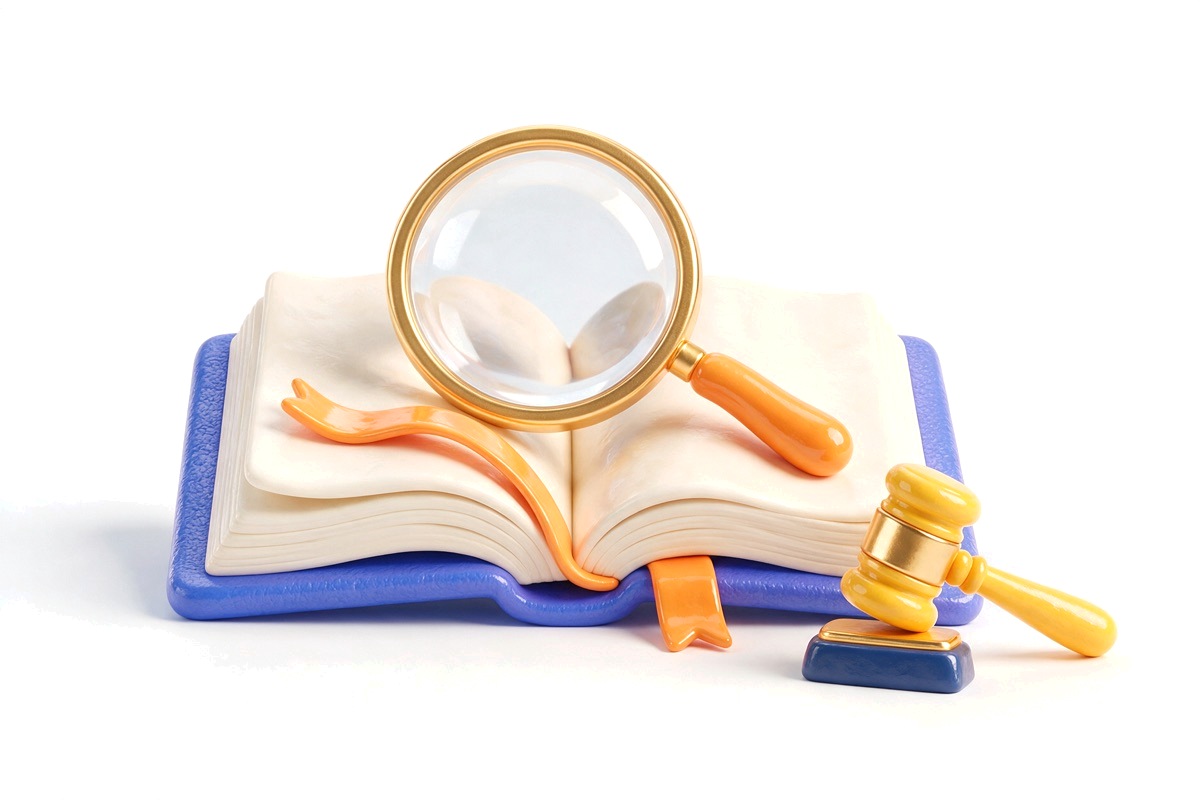 Magnifying glass over an open book with ribbon bookmark and a small gavel