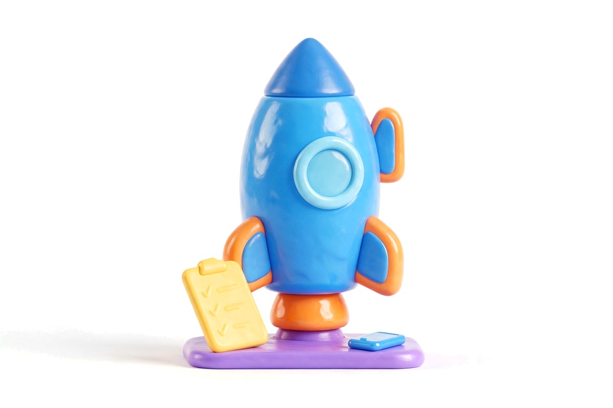 Toy rocket on a launchpad with a tick-marked clipboard and small phone
