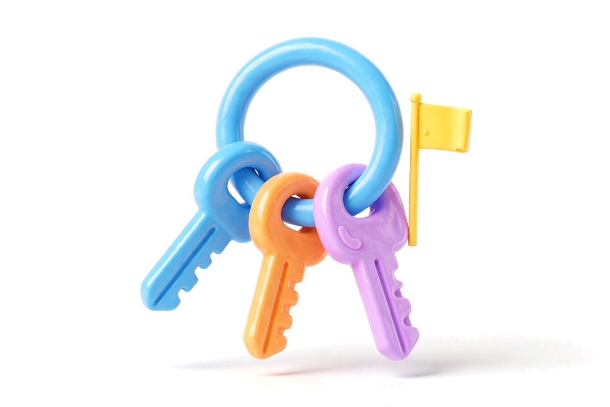 Key ring with three chunky keys and a small flag beside it
