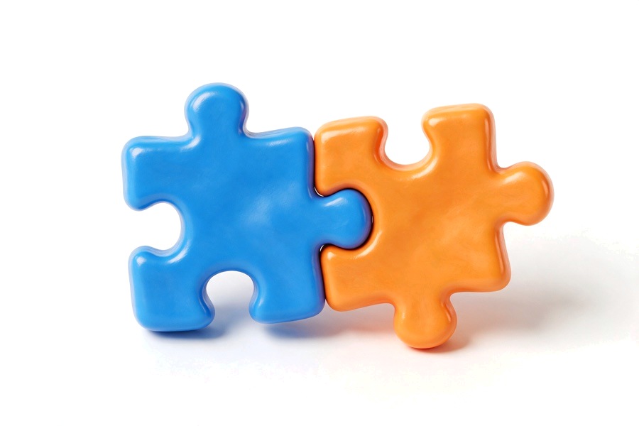 Two glossy 3D puzzle pieces fitting together